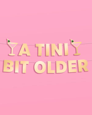 Tini Bit Older Banner - gold foil banner